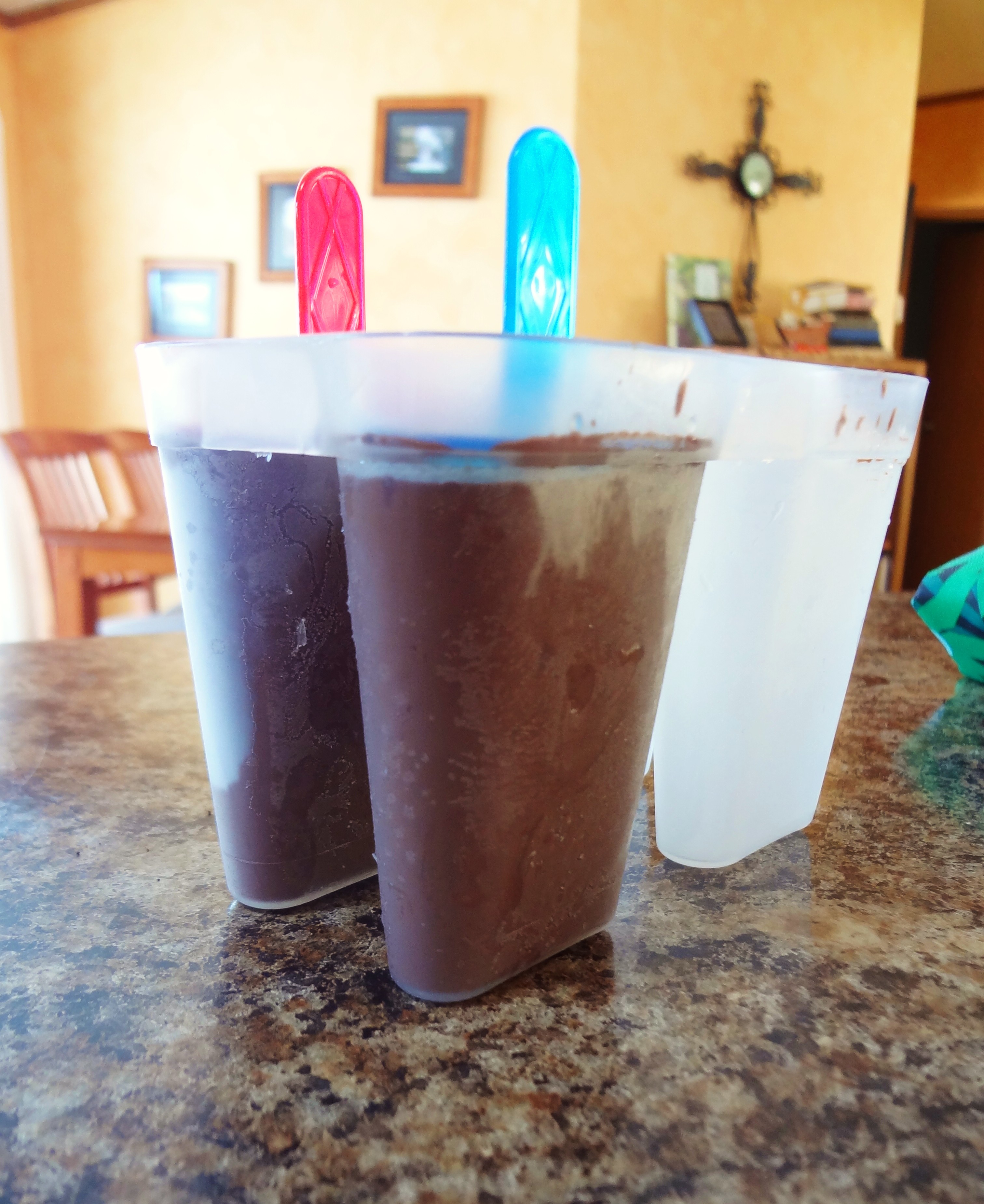 Craving a chocolatey frozen treat? Make these dairy free, soy free, and peanut free Dark Chocolate Popsicles (aka Fudgesicles) for a cool treat that's healthier than store-bought - @TheFitCookie #dairyfree #grainfree #glutenfree #popsicles